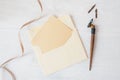 Mockup holiday letter Blank paper and an envelope with pen on wood table, with space for your text, top view Royalty Free Stock Photo