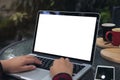 Mockup image of business woman using and typing on laptop with blank white screen , smart phone and coffee cups on glass table Royalty Free Stock Photo