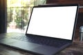 Mockup image of computer laptop with blank white desktop screen on wooden table Royalty Free Stock Photo