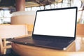 Computer laptop with blank white desktop screen on wooden table in cafe Royalty Free Stock Photo