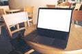 Mockup image of computer laptop with blank white desktop screen on wooden table Royalty Free Stock Photo