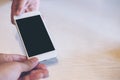 Mockup image of a hand holding , showing and giving white smart phone with blank black screen to another person to receive Royalty Free Stock Photo