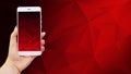 Mockup image of hands holding white mobile phone with red screen Royalty Free Stock Photo