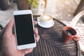 Mockup image of man`s hands holding white mobile phone with blank black desktop screen Royalty Free Stock Photo