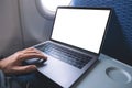 A man using and touching on laptop computer touchpad with blank white desktop screen while sitting in the cabin Royalty Free Stock Photo