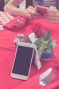 Mockup image of white mobile phone with blank white screen on red background in restaurant. Tropical Bali island Royalty Free Stock Photo