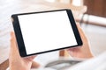 A woman holding black tablet pc with blank white screen horizontally Royalty Free Stock Photo