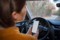 Mockup image of a woman holding and using mobile phone