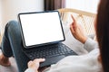 A woman using black tablet pc with blank desktop white screen as a computer pc while lying on a sofa at home Royalty Free Stock Photo