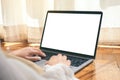 A woman using laptop computer with blank white desktop screen while laying down on the floor with feeling relaxed Royalty Free Stock Photo