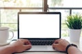 Mockup image of a woman using laptop and presenting with blank white screen for advertising text Royalty Free Stock Photo