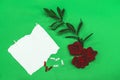 Mockup invitation, blank greeting card and red roses flowers and clothespin. Flat lay, top view Royalty Free Stock Photo