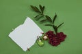 Mockup invitation, blank greeting card and red roses flowers and perfume bottle. Flat lay, top view Royalty Free Stock Photo