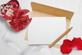 Mockup kraft envelope and a letter with a heart-shaped gift with a red bow and rose petals, greeting card for Valentines Royalty Free Stock Photo