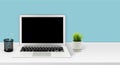 Mockup laptop computer display blank screen on desk in office, workspace with mock up computer screen empty and keyboard Royalty Free Stock Photo