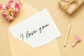 Mockup letter and envelop on craft wood with I love you text and kraft gift box. Mock up for elegant design. Flat lay top view