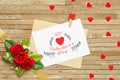 Mockup letter and envelop on wood with with happy valtentine`s day text and red roses and red hearts. Mock up for elegant design. Royalty Free Stock Photo