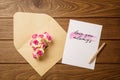 Mockup letter and envelop on wood with love you always text and kraft flowers. Mock up for elegant design. Flat lay top view