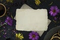 Mockup of letter on an envelope among wilted flowers, a cup of coffee and a vintage plate.