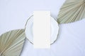 Mockup menu card with leaf palm on the plate and white background