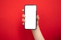 Mockup of mobile phone in hand on bright red colored background, copy space photo Royalty Free Stock Photo
