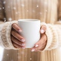 Mockup of a mug in the hands of a woman in a sweater, white mug Royalty Free Stock Photo