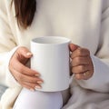 Mockup of a mug in the hands of a woman in a sweater, white mug Royalty Free Stock Photo