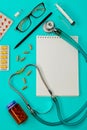 Stethoscope, pills, pen, notebook on the doctor desk Royalty Free Stock Photo