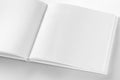 Mockup of opened blank square book at white design paper