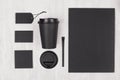 Mockup packing for coffee products and shop - black paper cup, blank paper, stationery, sugar on white wood table, top view.