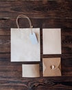 Mockup Paper bag from kraft paper with gift tag and Christmas gift boxes on a wooden background Royalty Free Stock Photo