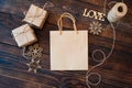 Mockup Paper bag from kraft paper and Christmas gift boxes on a wooden background Royalty Free Stock Photo