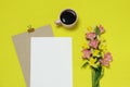 Mockup paper frame on the yellow background with flowers, cup of coffee