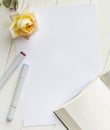 Mockup for A4 paper with single rose, book and drawing material Royalty Free Stock Photo