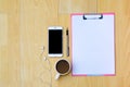 Mockup phone Coffee cups, earphones Note paper Placed on a wooden top view