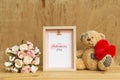 Mockup Picture frame and cute bear holding red heart with Bouquet of pink roses on rusty wood. Valentines Day Background concept Royalty Free Stock Photo