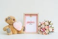 Mockup Picture frame and cute bear with pink heart and Bouquet of roses . Valentines Day Background concept with copy space. Mock Royalty Free Stock Photo