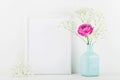 Mockup of picture frame decorated rose flower in vase on white background with clean space for text and design your blogging. Royalty Free Stock Photo