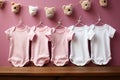 Mockup of pink baby bodysuits on pink background. Blank baby clothes template