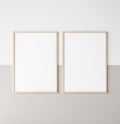 Mockup poster frame, two vertical wooden frames on beige and white wall