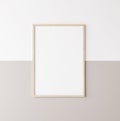 Mockup poster frame, vertical wooden frame on beige and white wall