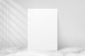 Mockup poster with shadow blinds from window. Mock up sheet paper. White empty blank. Vertical mockup. Light from window. Realisti Royalty Free Stock Photo