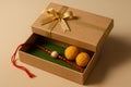 Mockup of Raksha Bandhan gift box with rakhi and ladoo, tilted front view Royalty Free Stock Photo