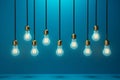 Mockup of row of hanging light bulbs on a blue background. Business idea Royalty Free Stock Photo