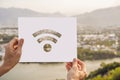 MOCKUP, SCENE CREATOR Wifi Internet icon in hands on a village background