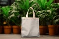 Mockup shopper tote bag handbag on green plants background. Copy space shopping eco reusable bag. Grocery accessories. Template