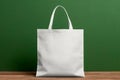 Mockup shopper tote bag handbag on isolated green wall background. Copy space shopping eco reusable bag. Grocery accessories.
