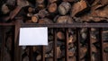 Mockup of sign fence with stacked firewood storage, natural background. Mock up