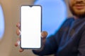 Mockup smartphone airplane. Young attractive european man holding blank screen smartphone in hands in airplane. Mock up for a game