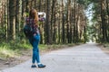 Mockup smartphone in the hands Girls in the forest, against a background of trees. Concept on the theme of travel outdoor.